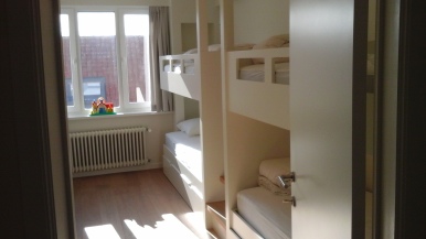 Bedroom 1 - 2 x 2 bunk beds with small central staircase + baby bed + sink